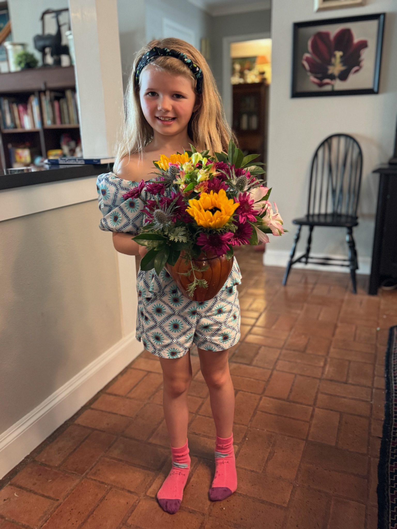 Harriet holding a beautiful bouquet of sunflowers